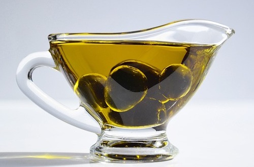 Picture of olive oil with whole olive fruits